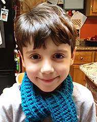 picture of a seven year old boy with a blue scarf